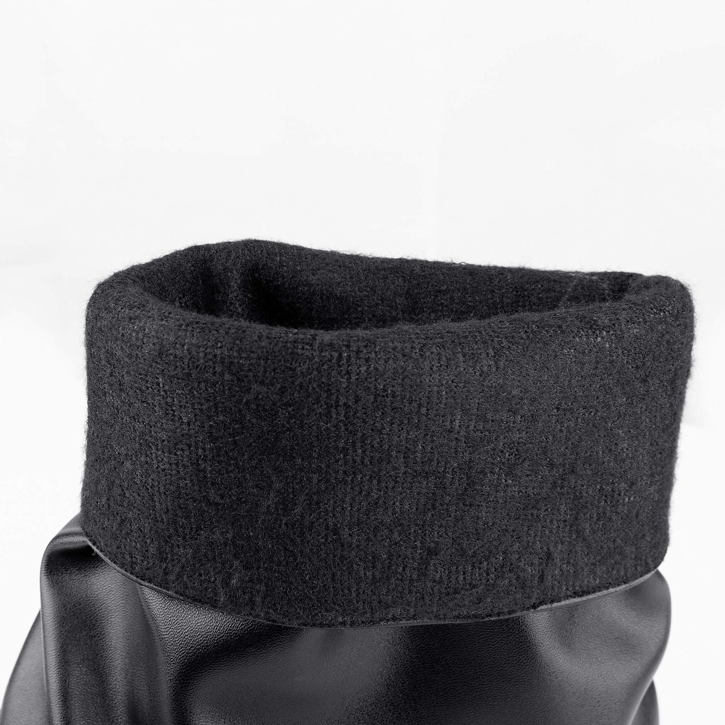 Close-up view of black moto mid calf biker boots, fold over shaft with soft fleece warm lining detail