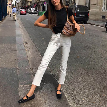 Model wearing black Mary Jane flats with tailored trousers for an office look