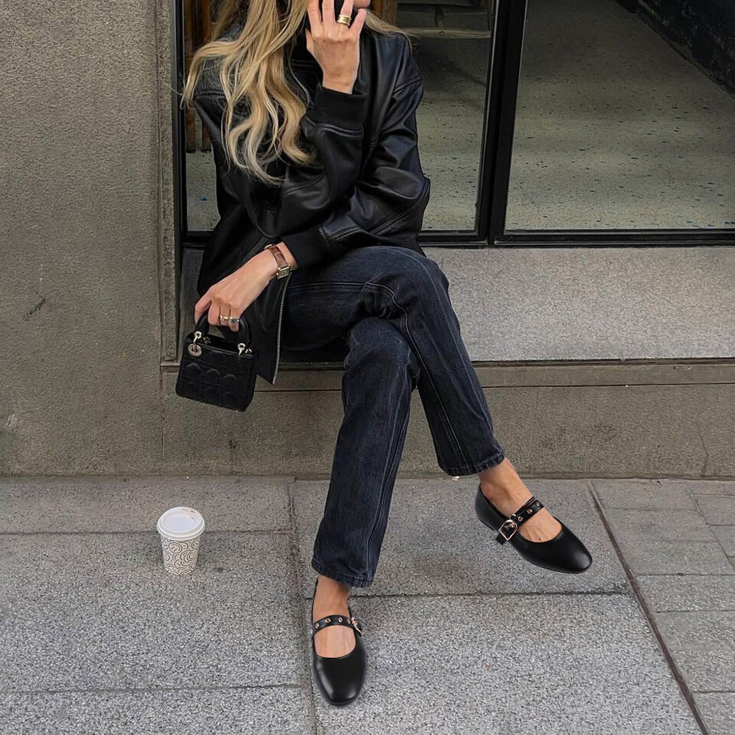 Model wearing black Mary Jane flats with jeans for a casual look