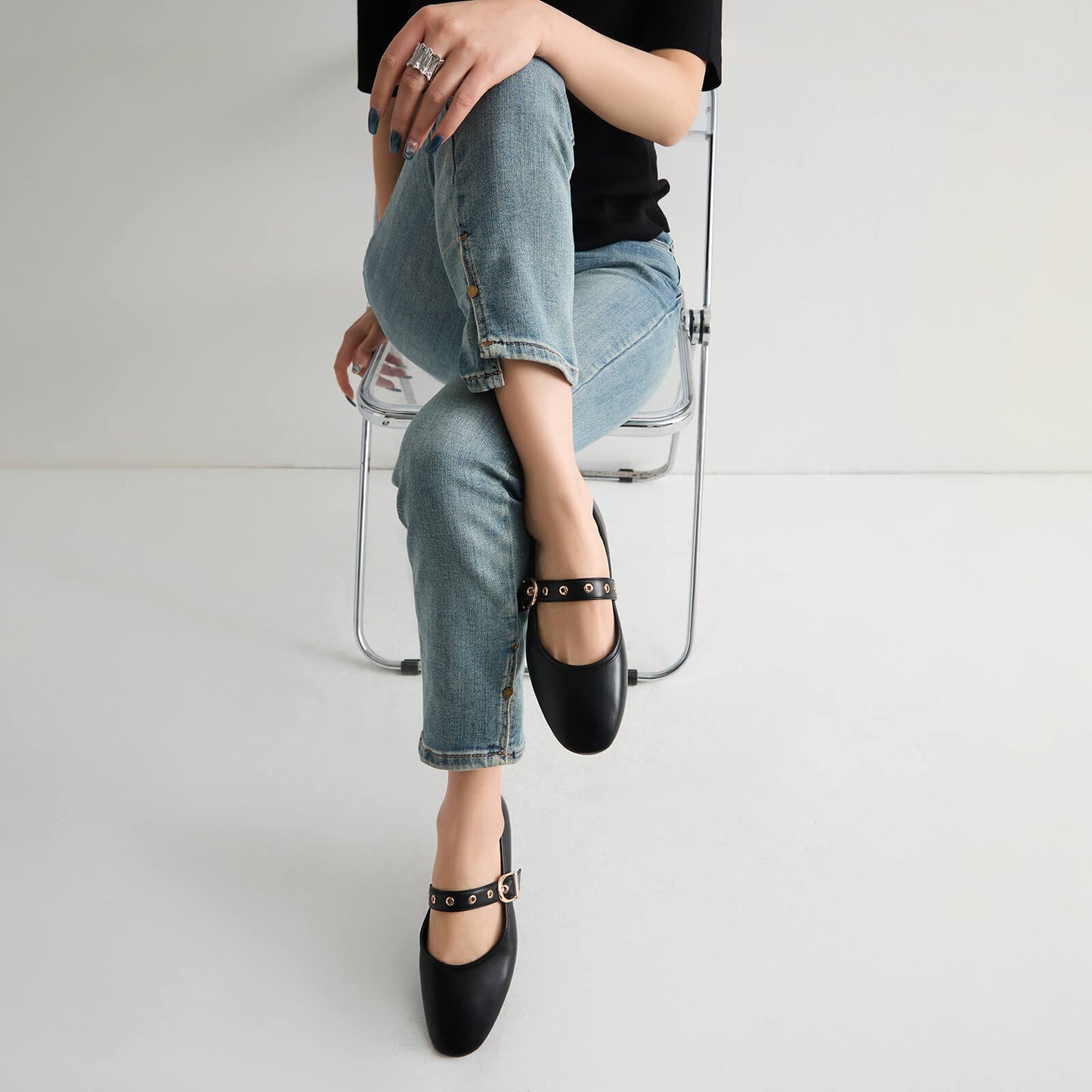 Model wearing black Mary Jane flats with jeans for an office look